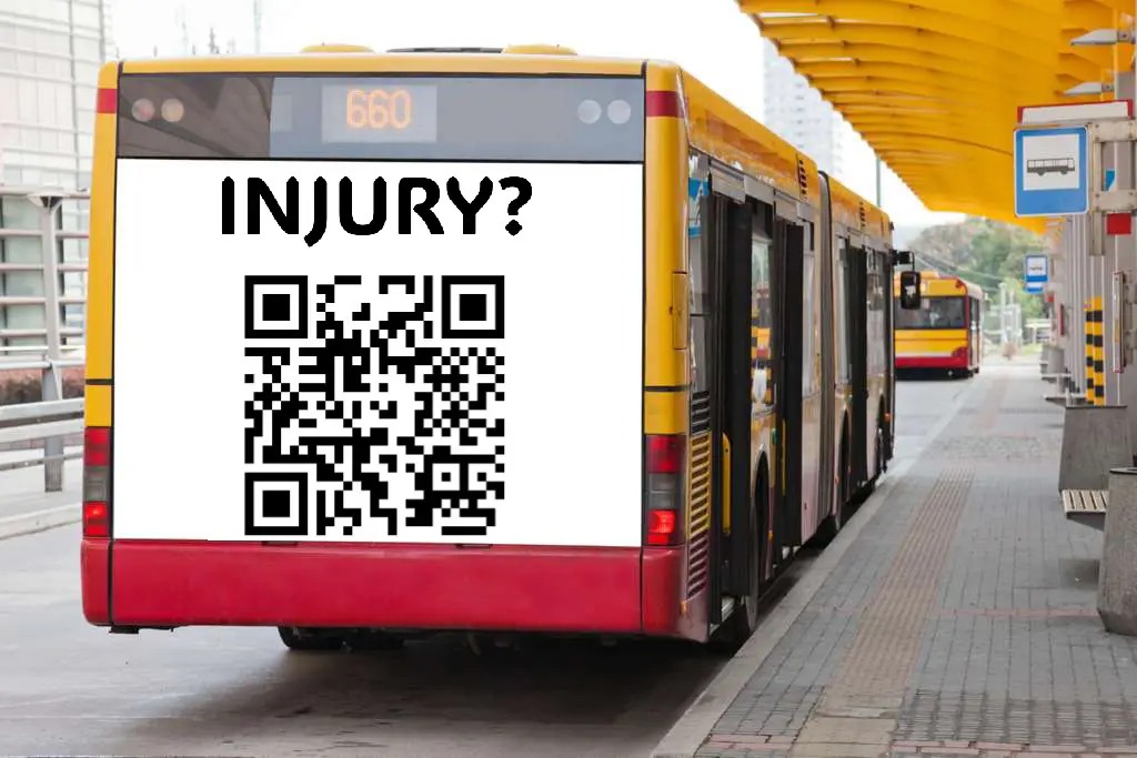 City bus rear ad with INJURY? headline and QR code at a transit stop